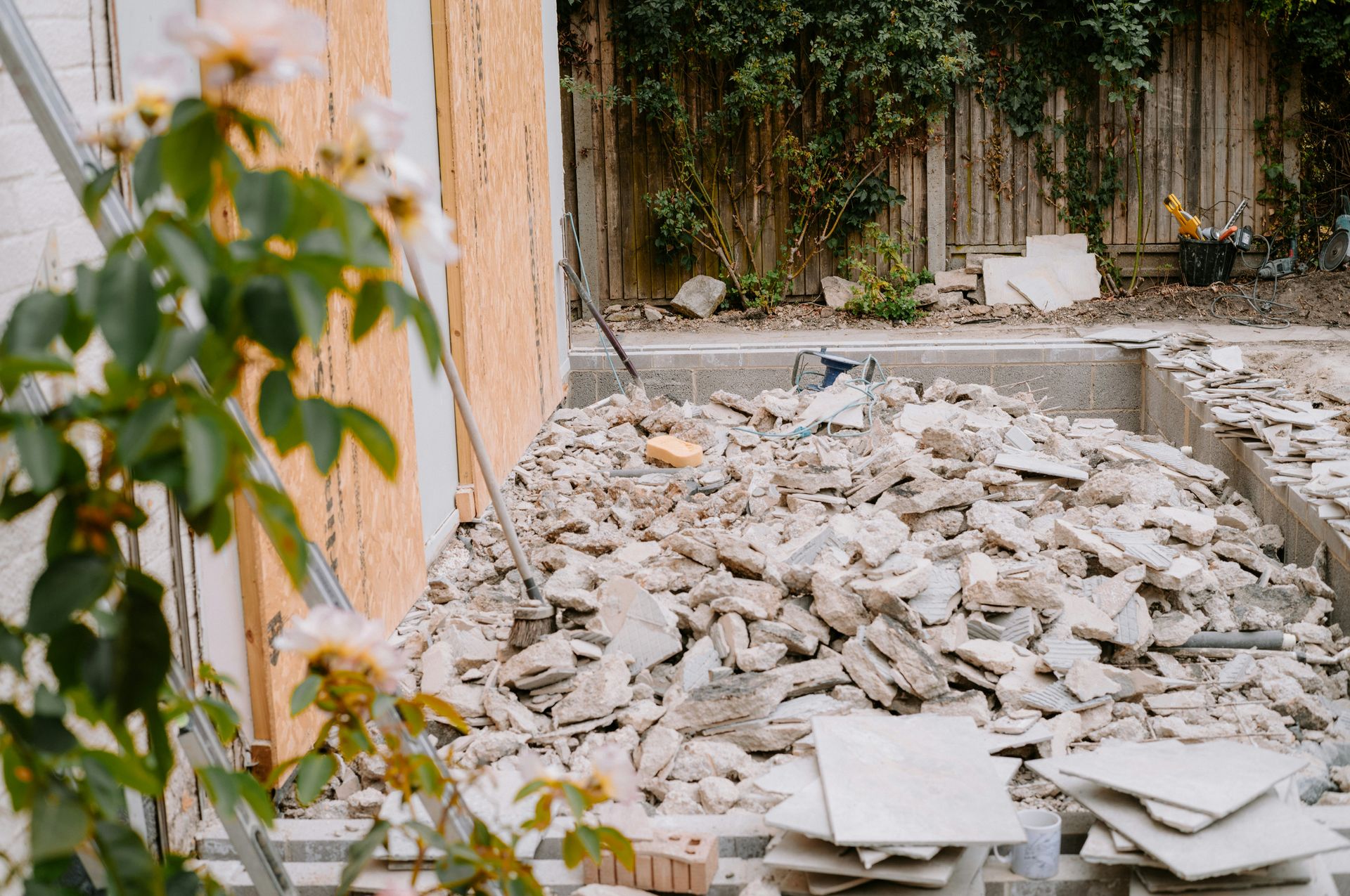 A pile of broken concrete rubble in a backyard construction site